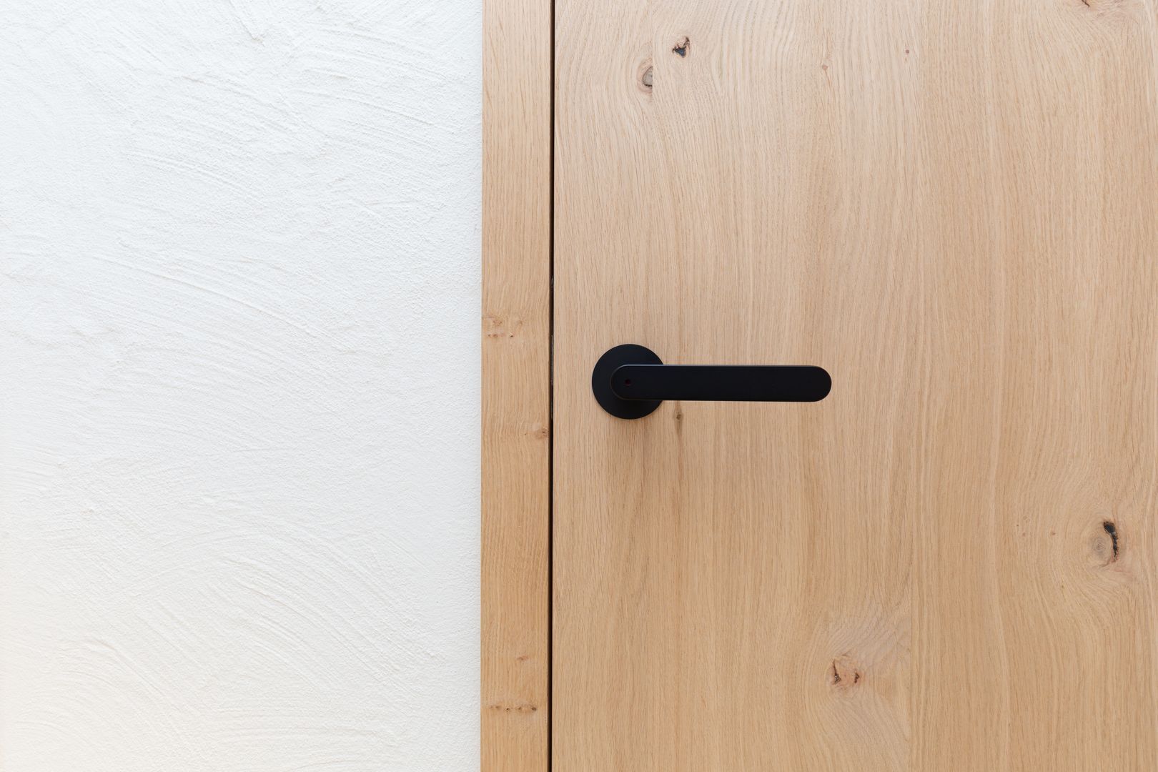 Türbeschläge in schwarz harmonieren perfekt mit Eichenholzfurnier